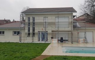 Maison en cours de rénovation avec échafaudages pour isolation thermique par l’extérieur